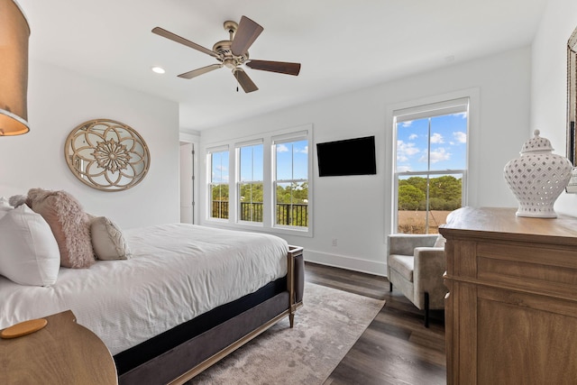 bedroom with dark hardwood / wood-style flooring and ceiling fan