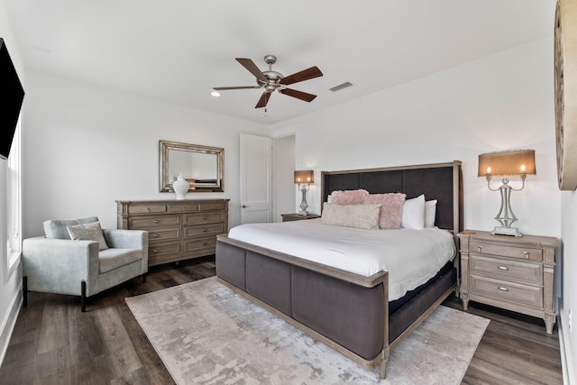 bedroom with ceiling fan and dark hardwood / wood-style floors