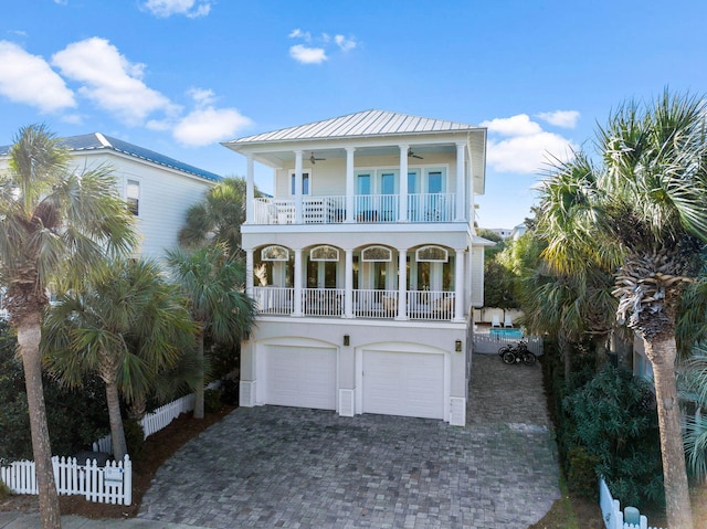 beach home with ceiling fan, a balcony, and a garage