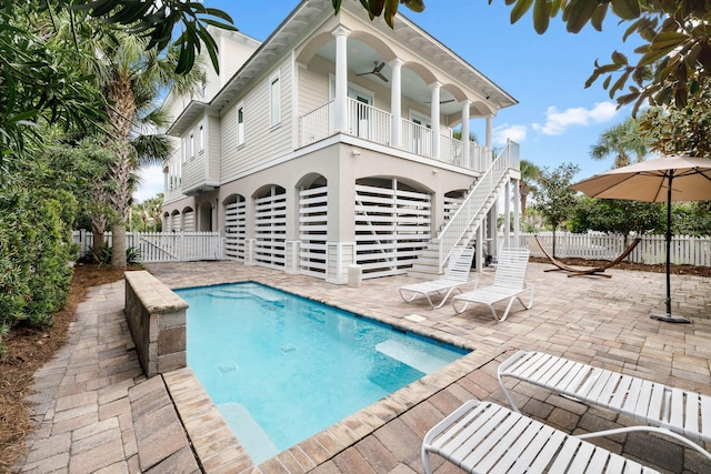 view of swimming pool with a patio and ceiling fan