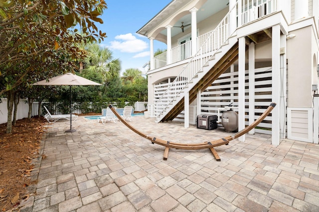 view of patio / terrace with a fenced in pool and a balcony