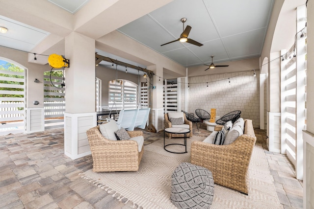 view of patio with an outdoor living space and ceiling fan