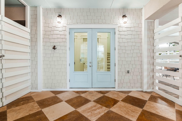 view of exterior entry featuring french doors