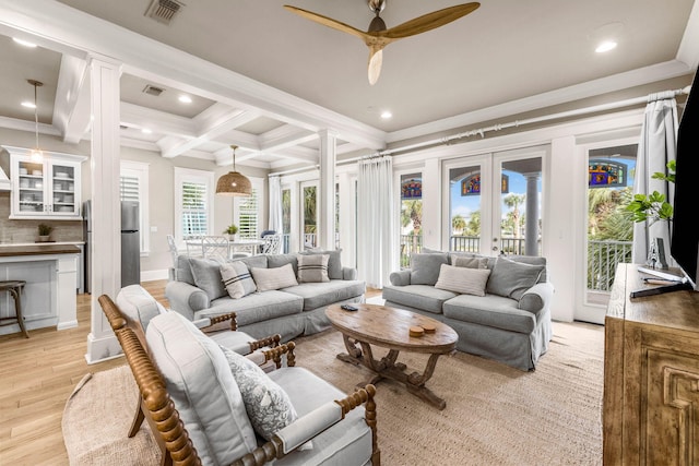 living room featuring beam ceiling, ceiling fan, coffered ceiling, light hardwood / wood-style flooring, and ornamental molding