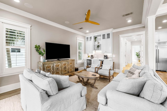 living room with ceiling fan, light hardwood / wood-style floors, and ornamental molding