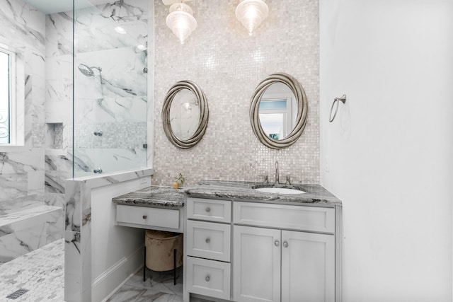 bathroom with decorative backsplash, a tile shower, vanity, and plenty of natural light