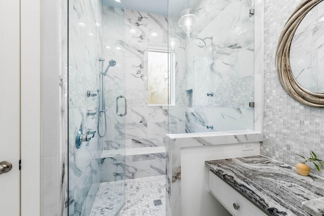 bathroom featuring vanity, walk in shower, and tile walls