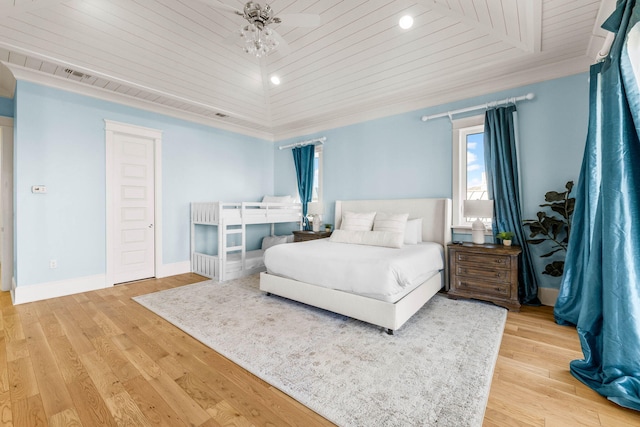 bedroom with ornamental molding, light wood-type flooring, and wooden ceiling