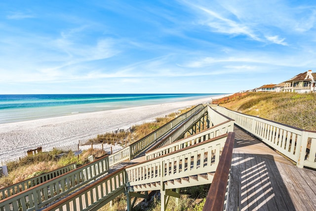 view of property's community with a water view and a view of the beach