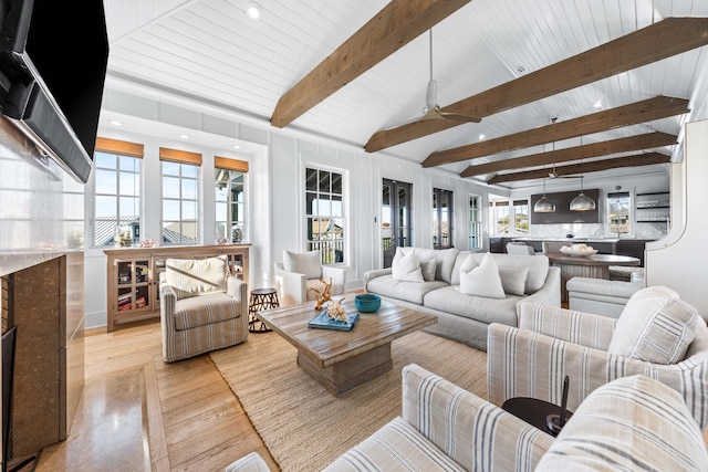 living room with lofted ceiling with beams, ceiling fan, and light hardwood / wood-style flooring