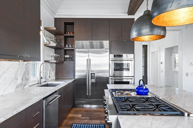 kitchen featuring pendant lighting, dark wood-type flooring, sink, light stone countertops, and appliances with stainless steel finishes