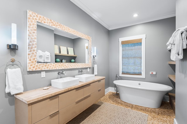 bathroom with vanity, ornamental molding, and a tub