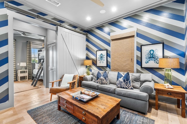 living room featuring a barn door and hardwood / wood-style flooring