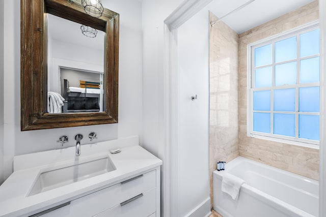 bathroom with vanity and a bath