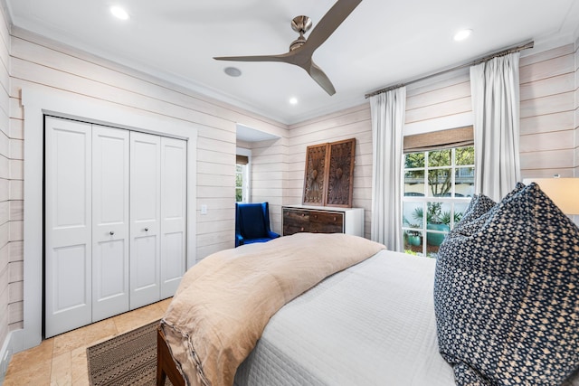 bedroom featuring a closet, ceiling fan, and crown molding