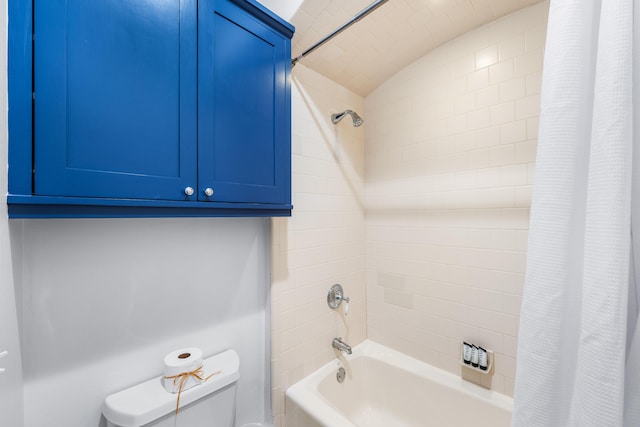 bathroom featuring lofted ceiling, shower / bath combo, and toilet