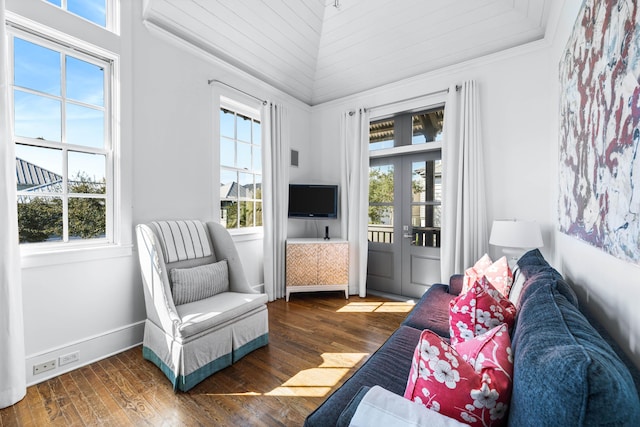 living area featuring french doors, dark hardwood / wood-style floors, and ornamental molding