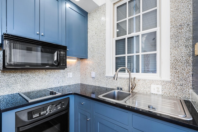 kitchen featuring wall oven, stovetop, and blue cabinetry