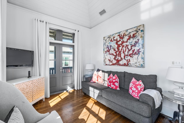 living room with ornamental molding and dark wood-type flooring