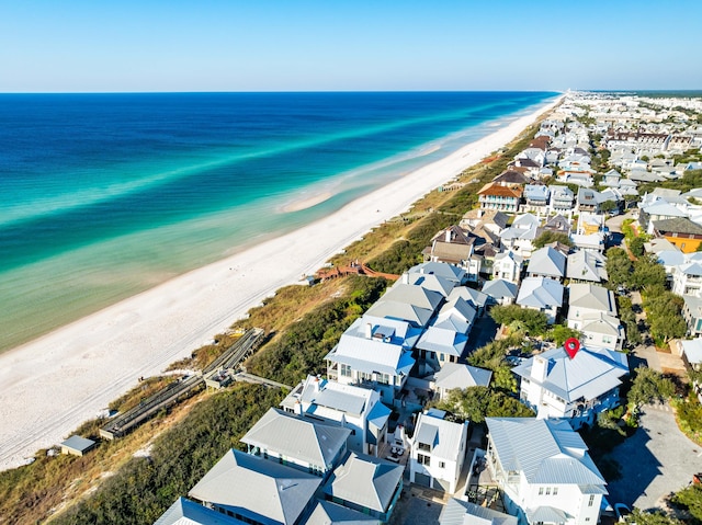 bird's eye view featuring a water view and a beach view