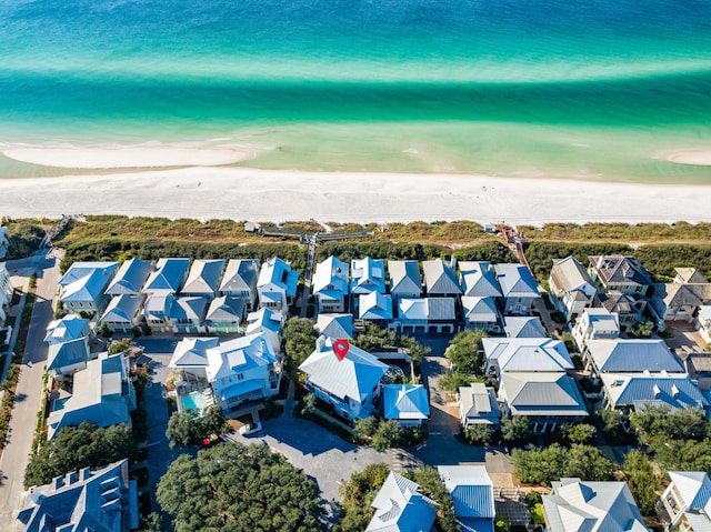 drone / aerial view with a water view and a beach view