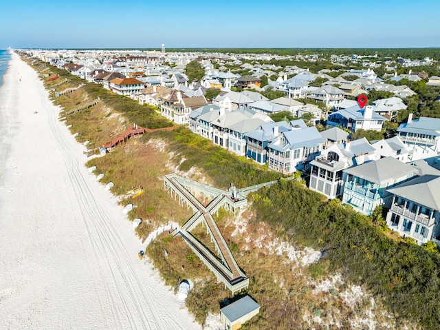 birds eye view of property featuring a water view and a view of the beach