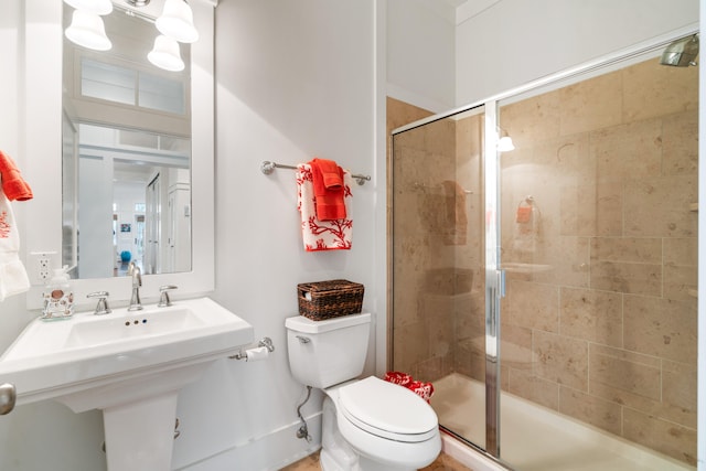 bathroom featuring sink, toilet, and walk in shower