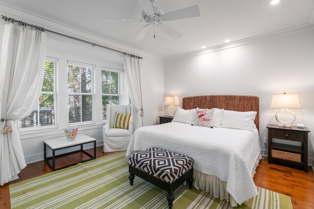 bedroom featuring ceiling fan, crown molding, and wood-type flooring