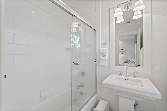 bathroom featuring crown molding and enclosed tub / shower combo