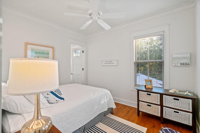 bedroom featuring ceiling fan, crown molding, and hardwood / wood-style flooring