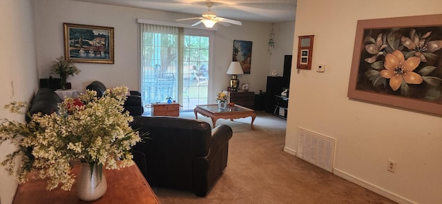 carpeted living room with ceiling fan