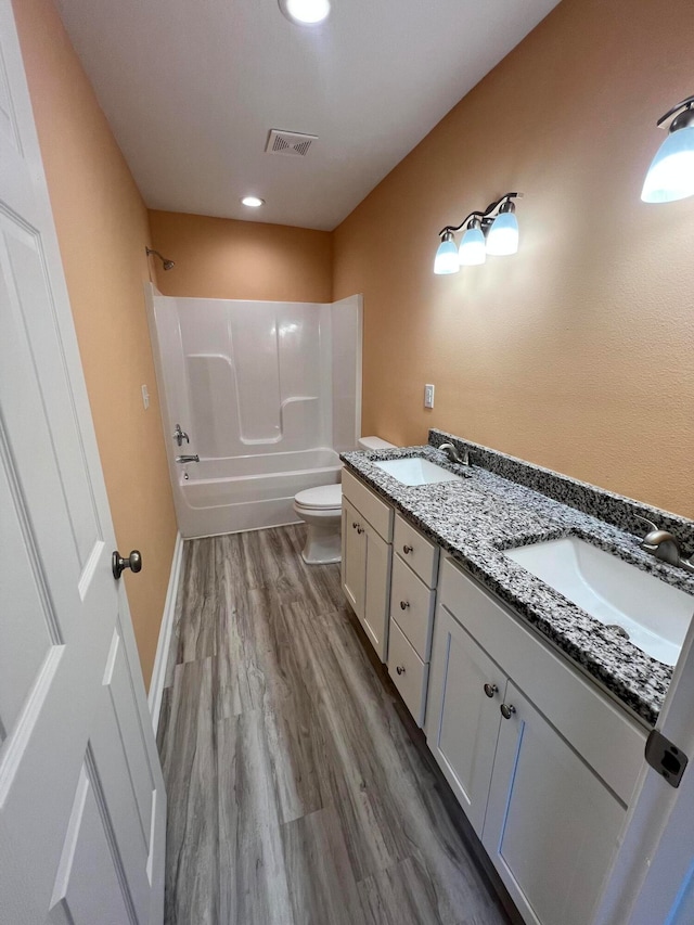 full bathroom with toilet, tub / shower combination, vanity, and hardwood / wood-style flooring