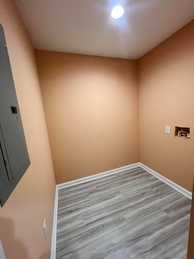 unfurnished room with light wood-type flooring and electric panel