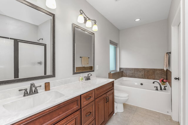 bathroom with vanity, a tub to relax in, tile patterned flooring, and toilet