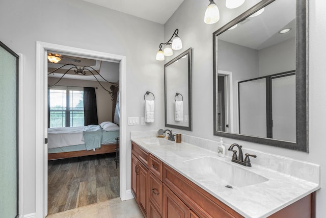 bathroom featuring vanity, an enclosed shower, and hardwood / wood-style floors