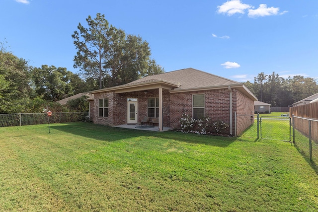 back of house featuring a patio area and a yard