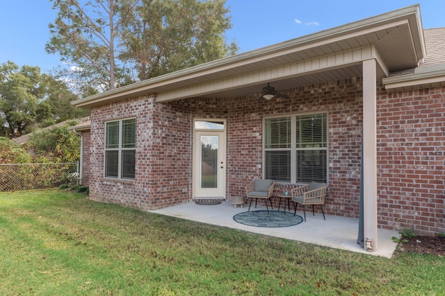 rear view of house with a patio, a lawn, and ceiling fan