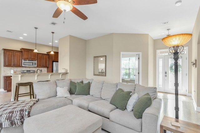 living room featuring light wood-type flooring and ceiling fan