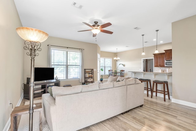 living room featuring ceiling fan and light wood-type flooring