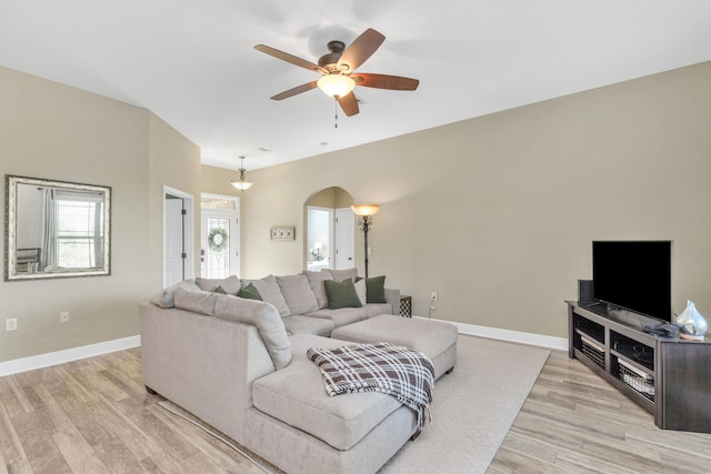 living room with ceiling fan and light hardwood / wood-style floors