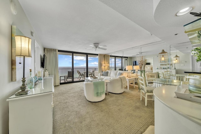 4100 E Co Hwy Unit 30A 1102 # 1102, Santa Rosa Beach, FL 32459 - carpeted living area featuring a ceiling fan and expansive windows
