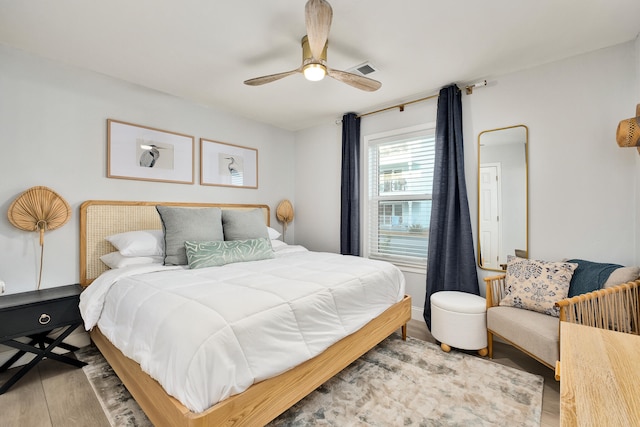 bedroom with ceiling fan and light hardwood / wood-style floors