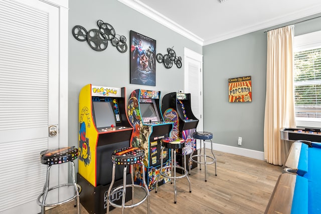 playroom featuring light hardwood / wood-style floors and crown molding