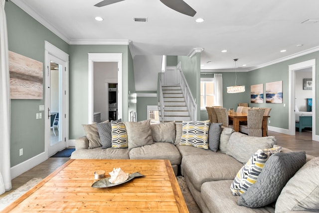 living room with hardwood / wood-style floors, ceiling fan, and crown molding