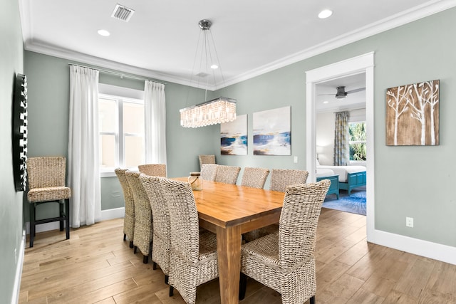 dining room with ceiling fan, crown molding, and light hardwood / wood-style flooring