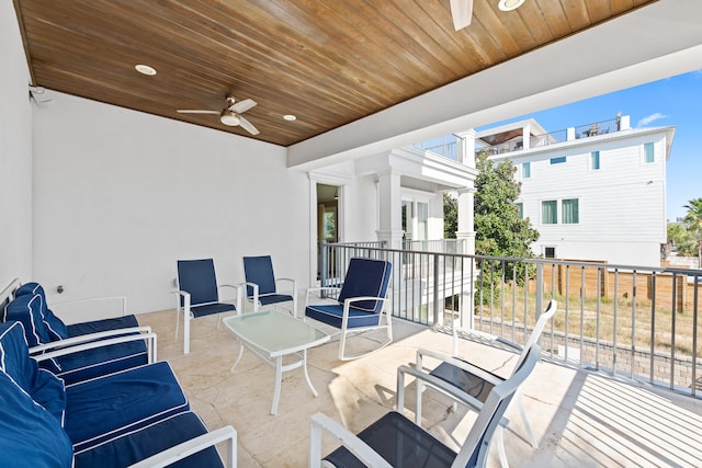 view of patio / terrace with ceiling fan and a balcony