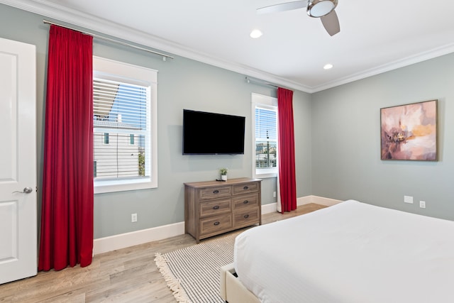 bedroom with ornamental molding, light wood-type flooring, multiple windows, and ceiling fan