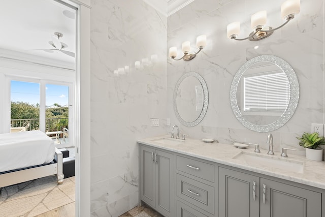 bathroom featuring ceiling fan, vanity, tile walls, and ornamental molding