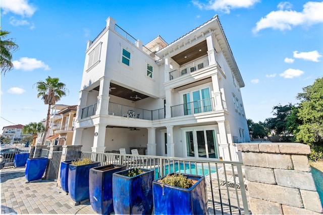 back of house featuring a balcony and a patio