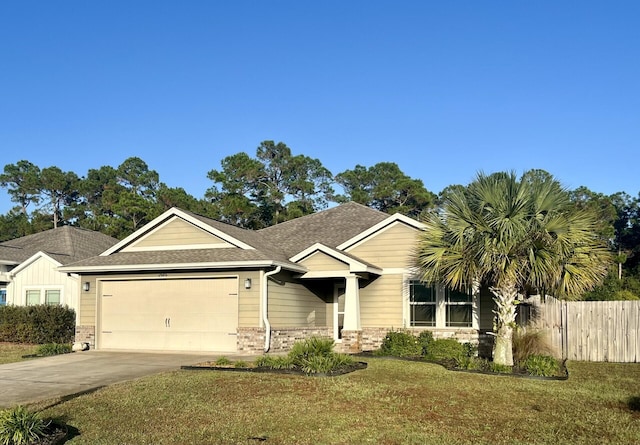 view of front of house featuring a garage and a front lawn